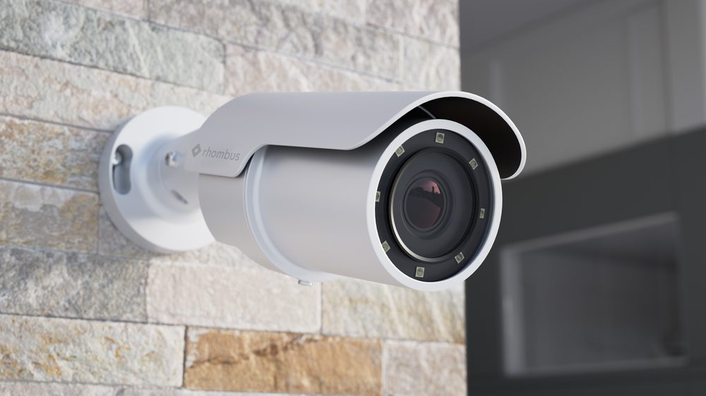Rhombus R540 4K outdoor bullet camera close-up, wall-mounted on stone facade